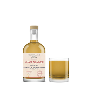 Nina's Sømmers cocktail bottle with a glass, featuring a light amber liquid and a wooden cap.-Cocktails by Nina