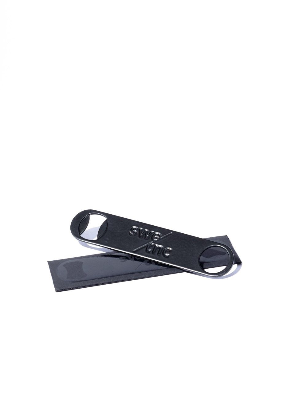 Swedish Tonic Blade, a black metal bottle opener with a sleek design and engraved logo.-Cocktails by Nina